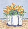 Bouquet of yellow flowers in a white beach tote on the beach